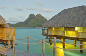 Bungalow overwater and a mountain in the evening